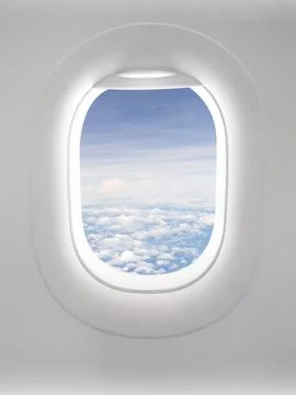 View of a clear sky with fluffy clouds in an open airplane cabin. Stock Photos