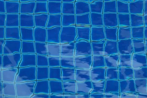 View of the clear water in the pool with blue ceramic tiles Stock Photos