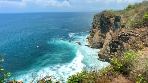 View from the cliff to the ocean, turquoise waves hit the rocks Stock Footage 122126840