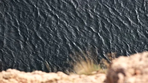 View from the cliff to the sea waves Stock Footage 204563825