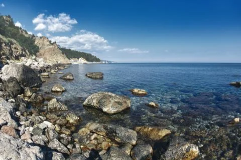 View on the cliffs and beach on the sea coast Stock Photos