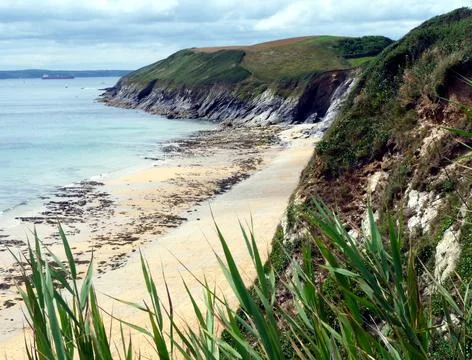 View of cliffs and pristine beach from coastal path, Cornwall, UK Stock Photos