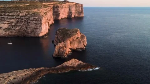 View of the Cliffs and Sea at Sunset in Malta Showing a Rock Formation and a Stock Footage 334930304