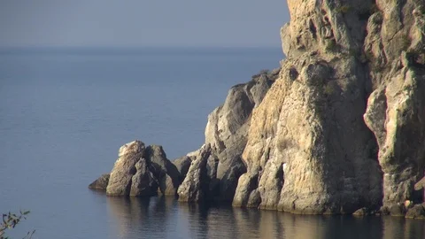 View of cliffs that close royal beach from waves at dawn. Close-up. Stock Footage 107584154