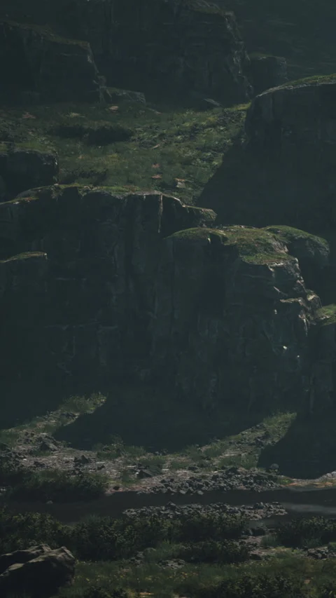 View of cliffs with green vegetation near a river in a valley in daytime Stock Footage 340884365