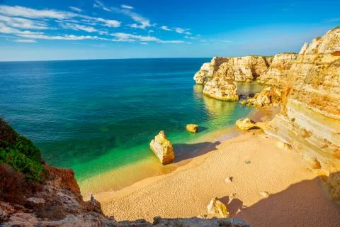 View from the cliffs over the emblematic golden beach of Praia M Stock Photos