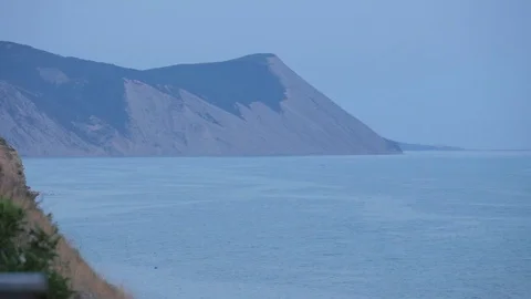 View of the cliffs of the sea and mountains. Sunset ligft. Birds. Looping Stock Footage 79762926