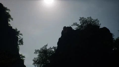 View of the cliffs with trees and grass as the sun goes down Stock Footage 231017632