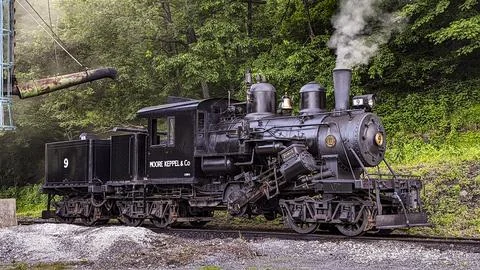 View of a Climax Restored Steam Engine Warming Up, By a Water Tower Stock Photos