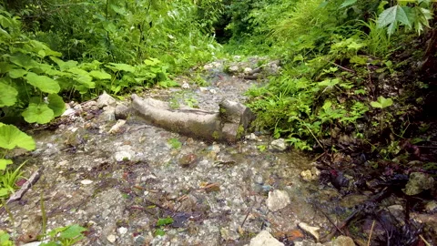 A view of climbing a mountain with a river full of water. Stockbeeldmateriaal 159042377