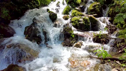 A view of climbing a mountain with a river full of water. Видео 159044825