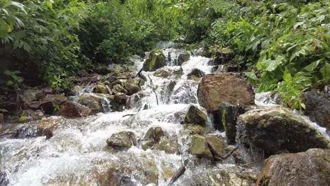 A view of climbing a mountain with a river full of water. 스톡 동영상 159058539