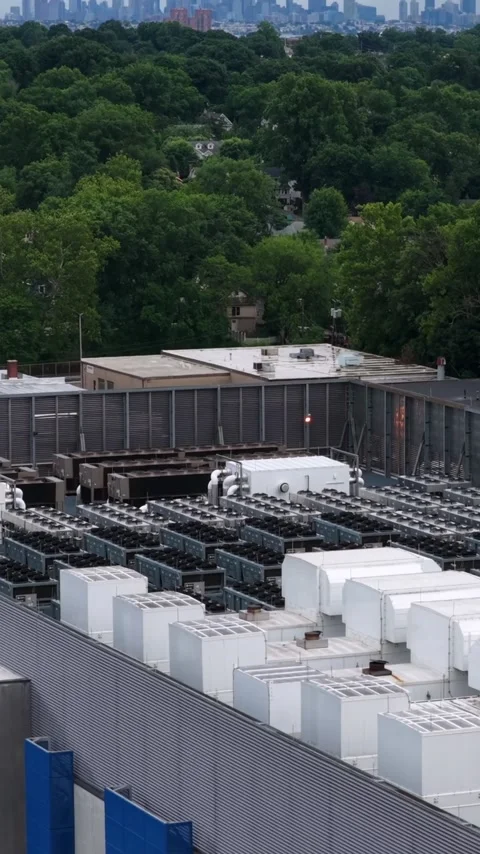 The view climbs a data center wall in Clifton, New Jersey to reveal a rooftop Stock Footage 345728301
