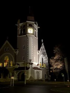View of the clock and facade of the Evangelical Church at night Stock Photos