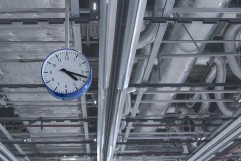 View of the clock that hangs from the ceiling against the background of venti Stock Photos