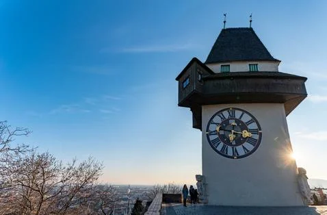 View at clock tower in Graz on a blue sky in winter Stock Photos
