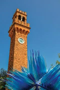 View of clock tower made of bricks and a star shape glass sculpture at Murano Stock Photos