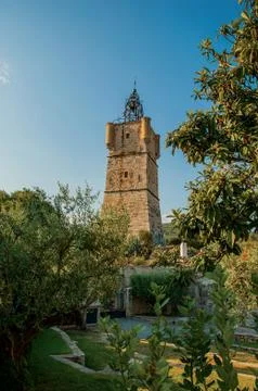 View of the clock tower made of stone on top of the hill at Draguignan. Stock Photos