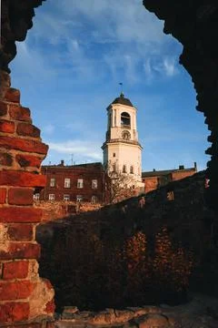 View of the Clock Tower from the ruins of the Old cathedral in the town of Stock Photos