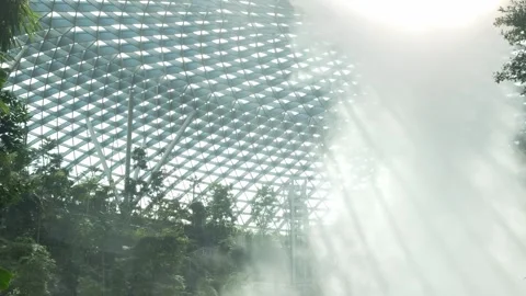 View close up to indoor vortex waterfall under modern glasses dome design w.. Stock Footage 259789095