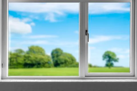 View from a closed window to a green meadow Stock Photos