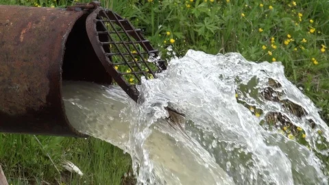 View of closeup dirty polluted water canal flow in river dangerous waste pouring Stock Footage 81966885
