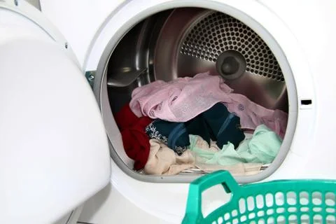 View clothes inside dryer with open door Stock Photos