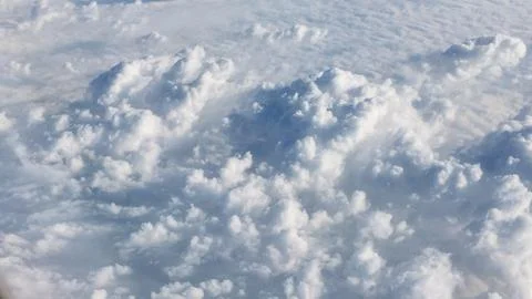 View of clouds from an airplane flying at a high altitude Stock Photos