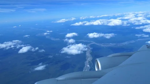 View of the Clouds and Land Below Seen From the Window of Military Aircraft Stock Footage 128552368