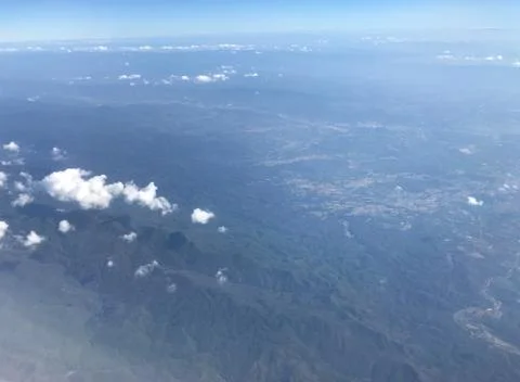 View of clouds and mountain and village landscape from the sky Stock Photos