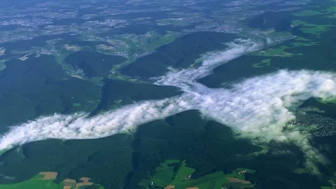 View of clouds and mountains from a flying plane Stock Footage 114887235
