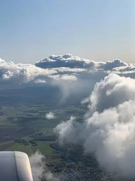 View of clouds and sky from an airplane window during flight Stock Photos