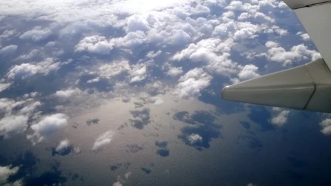 View of clouds below and sunset from an airplane Stock Footage 117351307