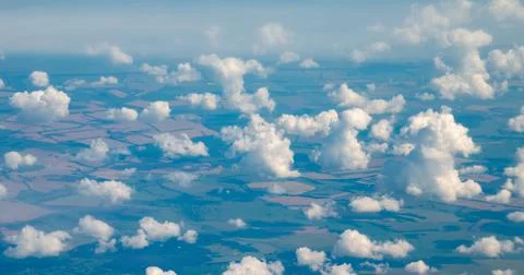 View of the clouds flying in the sky from the window of an airplane. Stock Photos