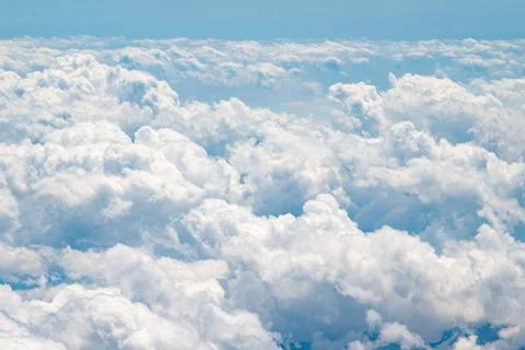 View of the clouds flying in the sky from the window of an airplane. Stock Photos
