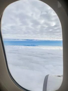 View of the clouds from inside the plane Stock Photos