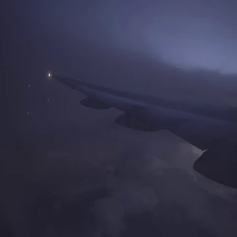 View of clouds, lightening rain from aircraft window in a bumpy ride. Stock Footage 69359358