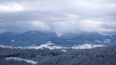 View of clouds over the snowed mountains Stock Footage 241807829