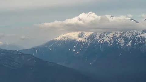 View of Clouds over snowy peaks Stock Footage 151130401