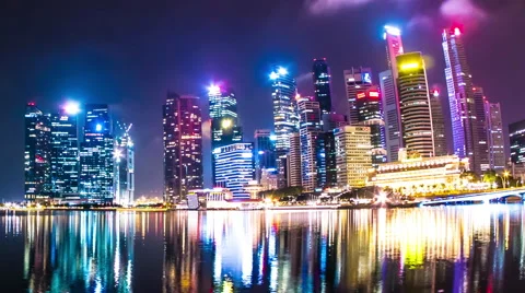 View as clouds pass by over the skyline of Singapore at night Stock Footage 64974278