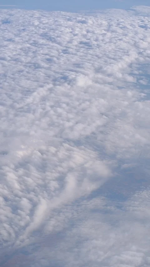 View of clouds from a plane flying in the sky Stock Footage 337981374