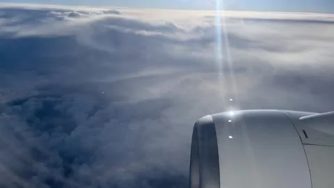 View of clouds from plane window over motor with clear weather Stock Footage 277289236