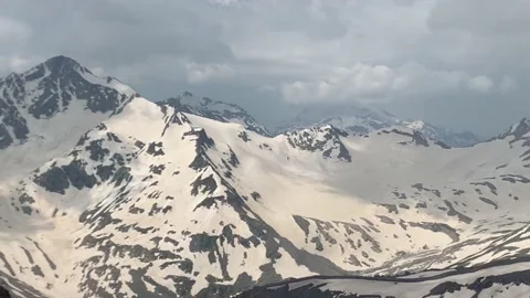 View of the clouds snow-capped mountains peaks Stock Footage 219376524