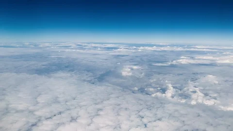 View of clouds through airplane window. Cloud layer below, midday light Stock Footage 103268238