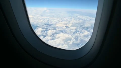 View of clouds through an airplane window Stock Footage 345844804