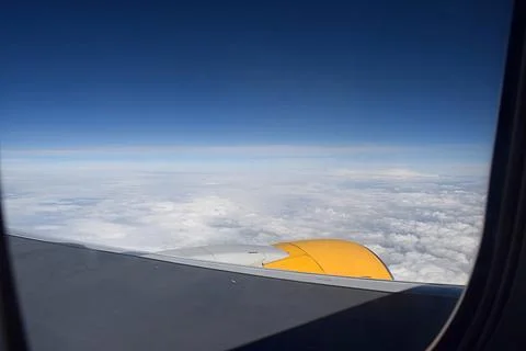 View of the clouds from the window of the aircraft. Stock Photos