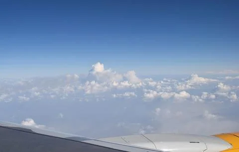 View of the clouds from the window of the aircraft. Stock Photos