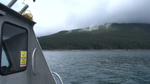 View of cloudy Alaskan shoreline from rocking fishing boat Stock Footage 66430758