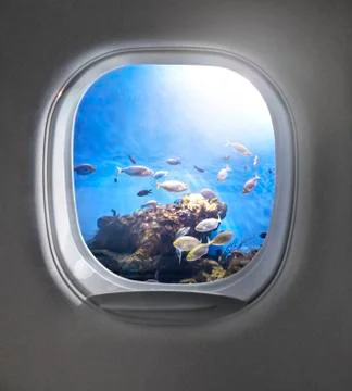 View of cloudy blue clear sky through airplane porthole. Stock Photos
