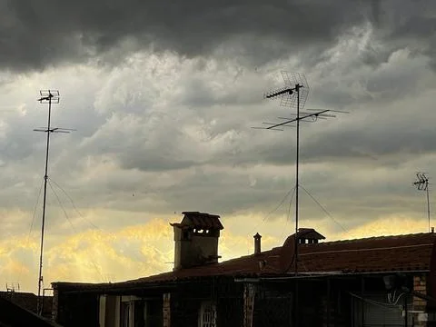 View of the cloudy sky and sunset before the storm, from the rooftops of Venice Stock Photos
